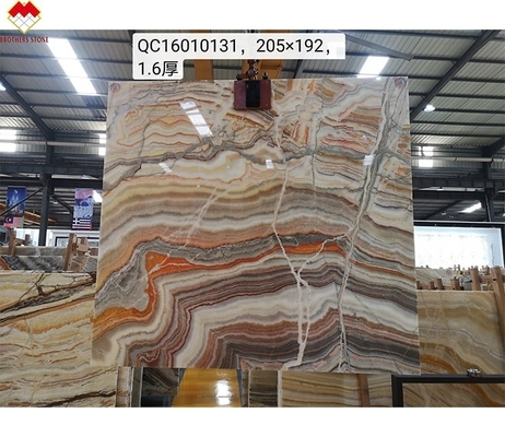 Pietra di onice arcobaleno traslucido per villa sfondo CNF lucidato marmo di onice drago rosso